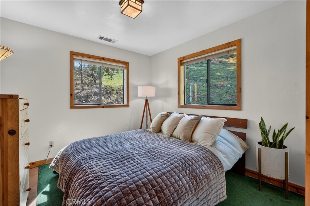 5851 Mt Bullion Ridge Road Mariposa, CA 95338 - Photo 19 of 58 a bedroom with a bed and a painting on the wall