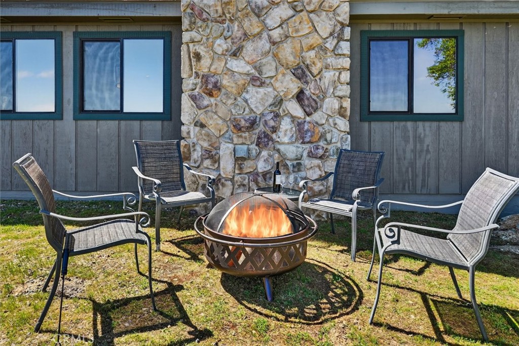 5851 Mt Bullion Ridge Road Mariposa, CA 95338 - Photo 32 of 58 a view of a chairs and table in backyard