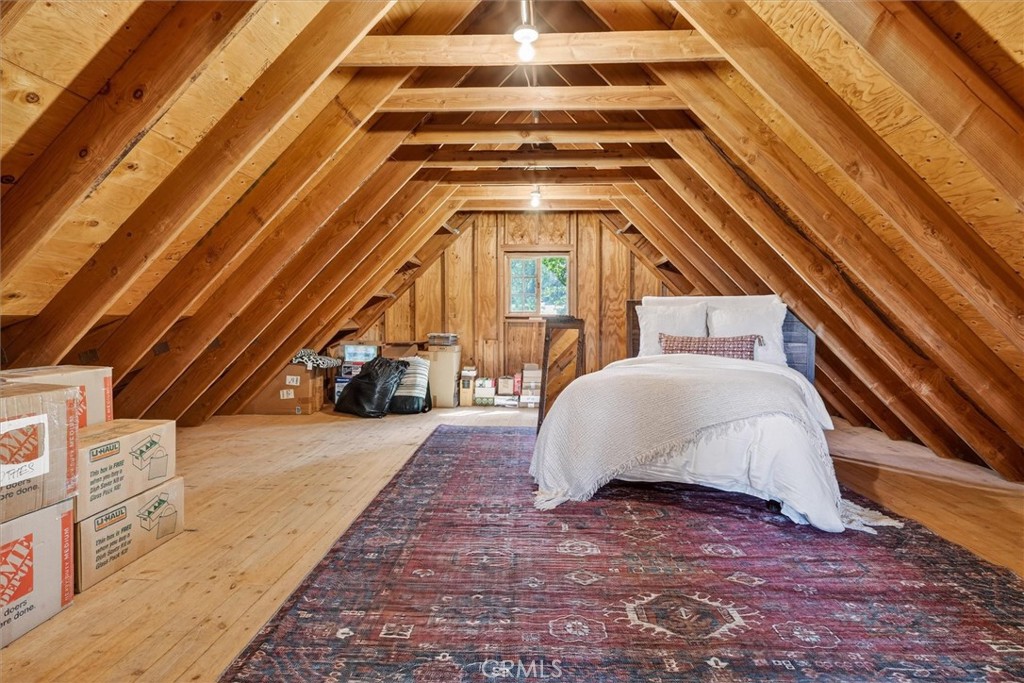 5851 Mt Bullion Ridge Road Mariposa, CA 95338 - Photo 47 of 58 a view of a bedroom with a bed and wooden floor
