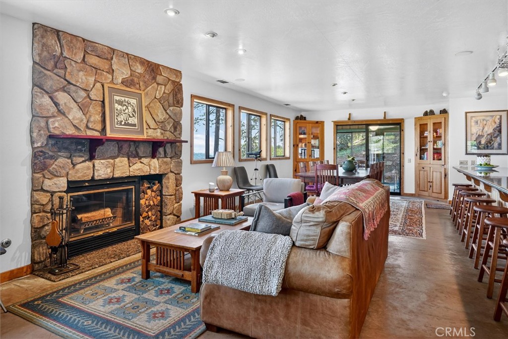 5851 Mt Bullion Ridge Road Mariposa, CA 95338 - Photo 6 of 58 a living room with furniture a flat screen tv and a fireplace