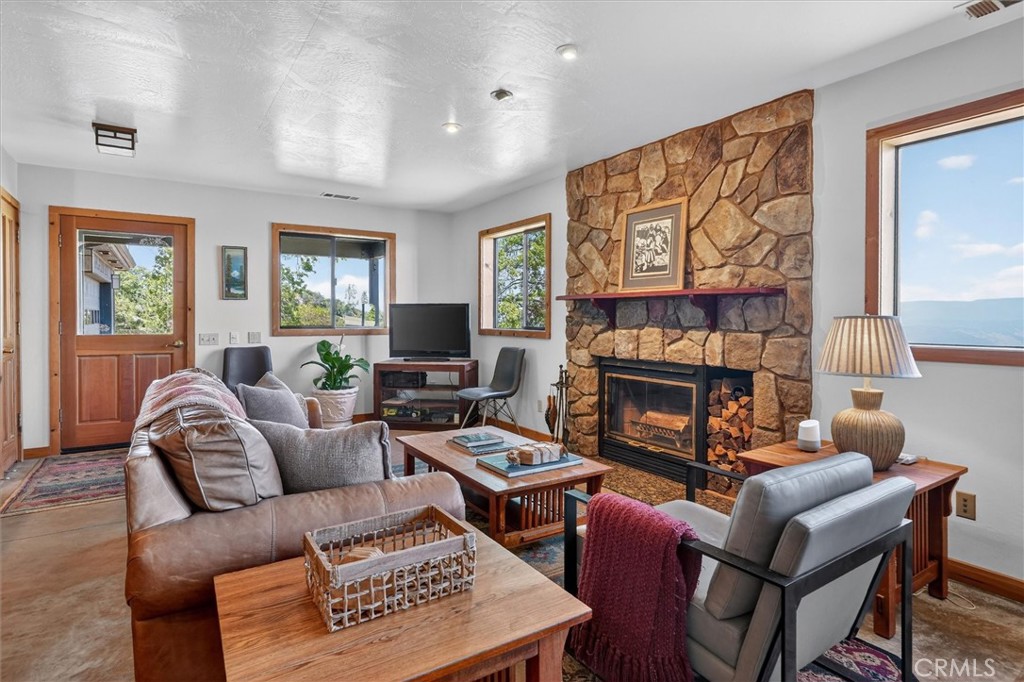 5851 Mt Bullion Ridge Road Mariposa, CA 95338 - Photo 7 of 58 a living room with furniture a fireplace and a flat screen tv