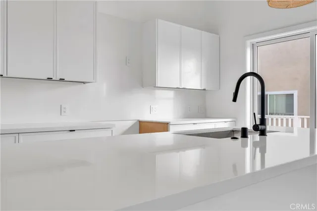 a kitchen with stainless steel appliances a sink and cabinets