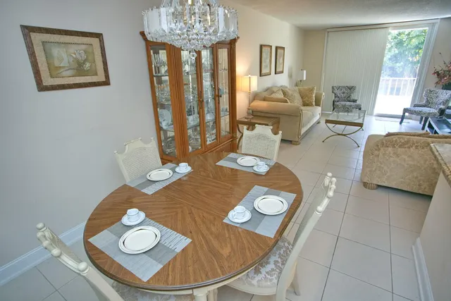 a view of a dining room with furniture and a chandelier