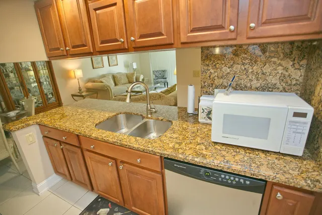 a kitchen with stainless steel appliances granite countertop a stove and a refrigerator