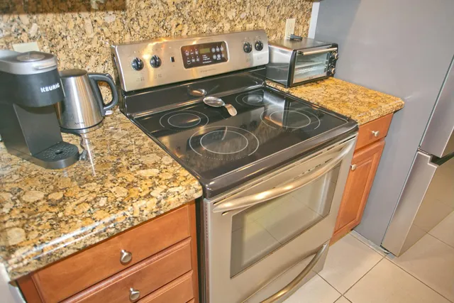 a stove top oven sitting inside of a kitchen