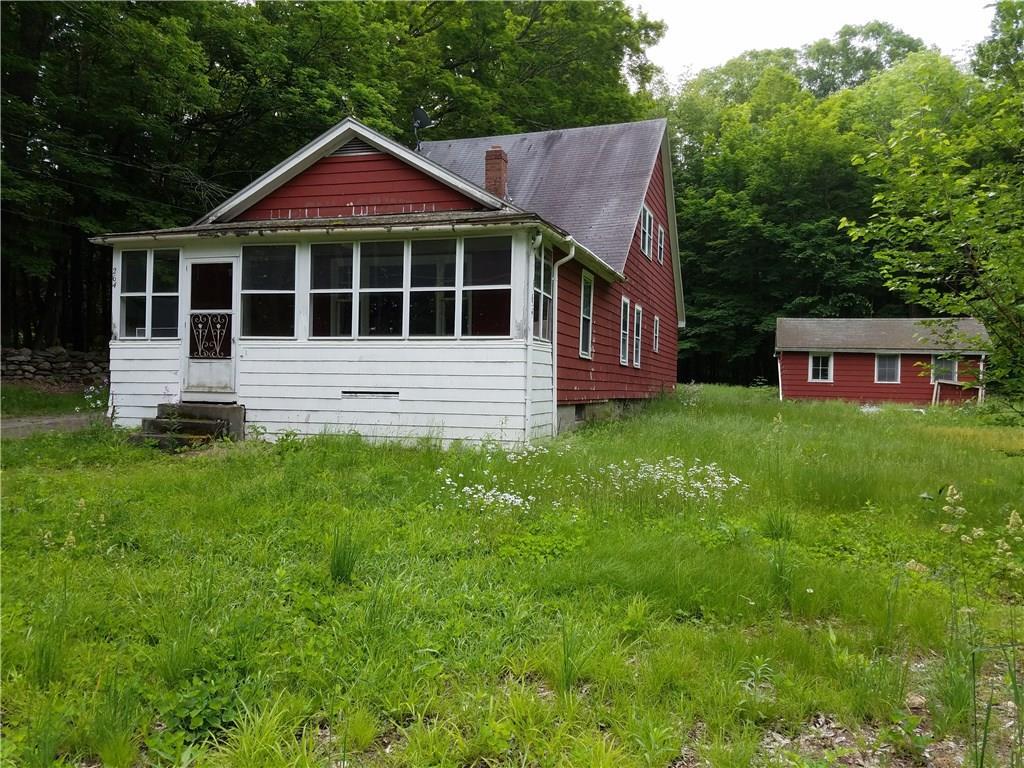 264 South Bear Hill Road Chaplin, CT 06235 - Photo 1 of 1 a front view of a house with a yard and garage