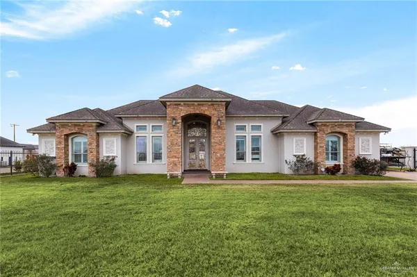 a front view of a house with a yard