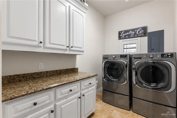 a utility room with sink dryer and washer