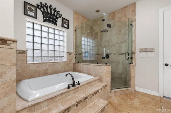 a bathroom with a bathtub and shower