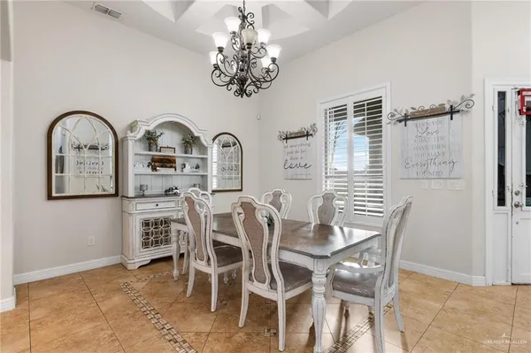 a view of a dining room with furniture and chandelier