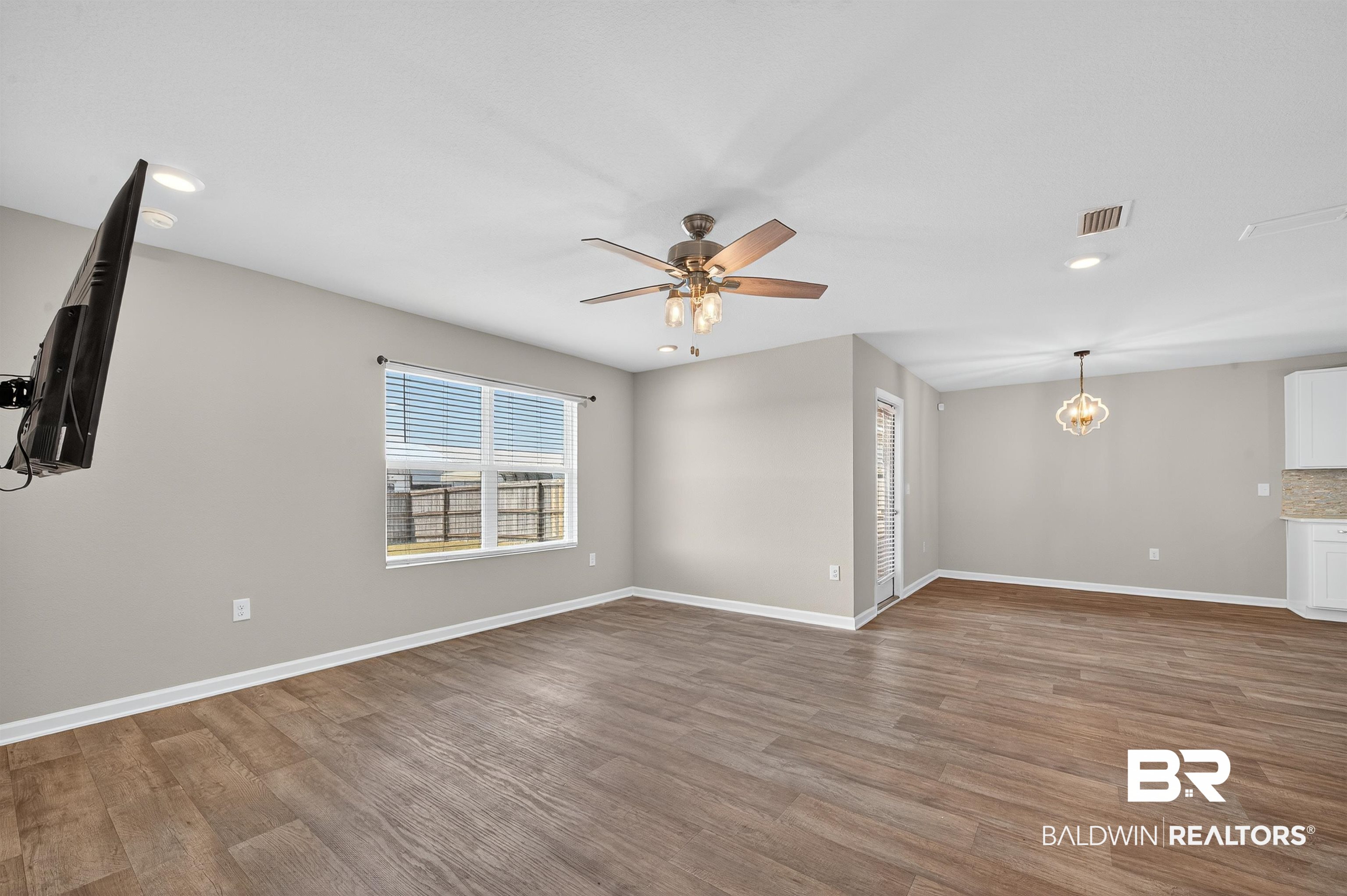 7429 Brompton Drive Foley, AL 36535 - Photo 18 of 50 Unfurnished living room featuring recessed lighting, wood finished floors, a ceiling fan, and a chandelier