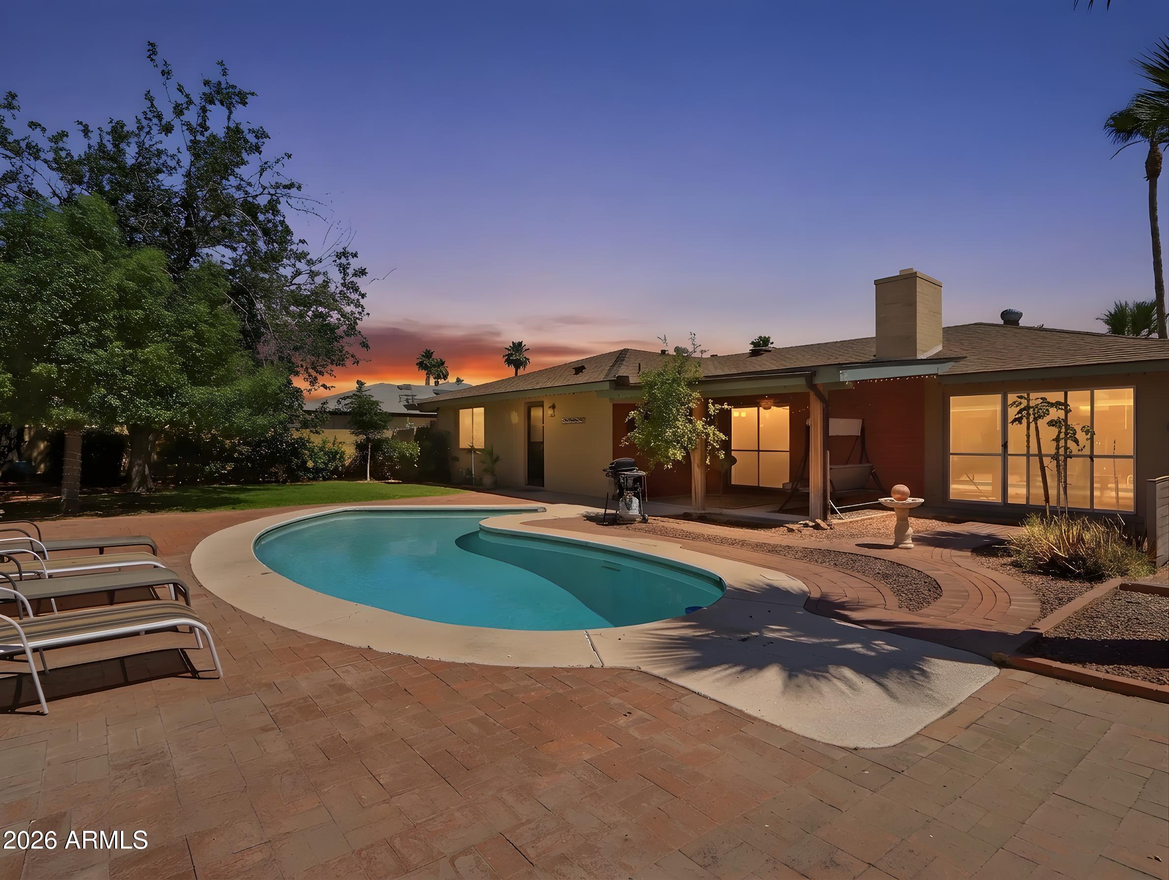 450 Cascada Road Litchfield Park, AZ 85340 - Photo 39 of 40 a view of a house with swimming pool and sitting area