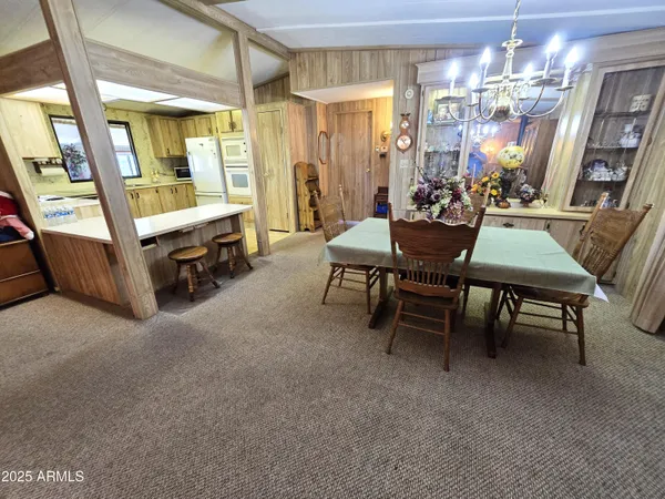 a kitchen with stainless steel appliances a sink a stove a refrigerator cabinets and a window