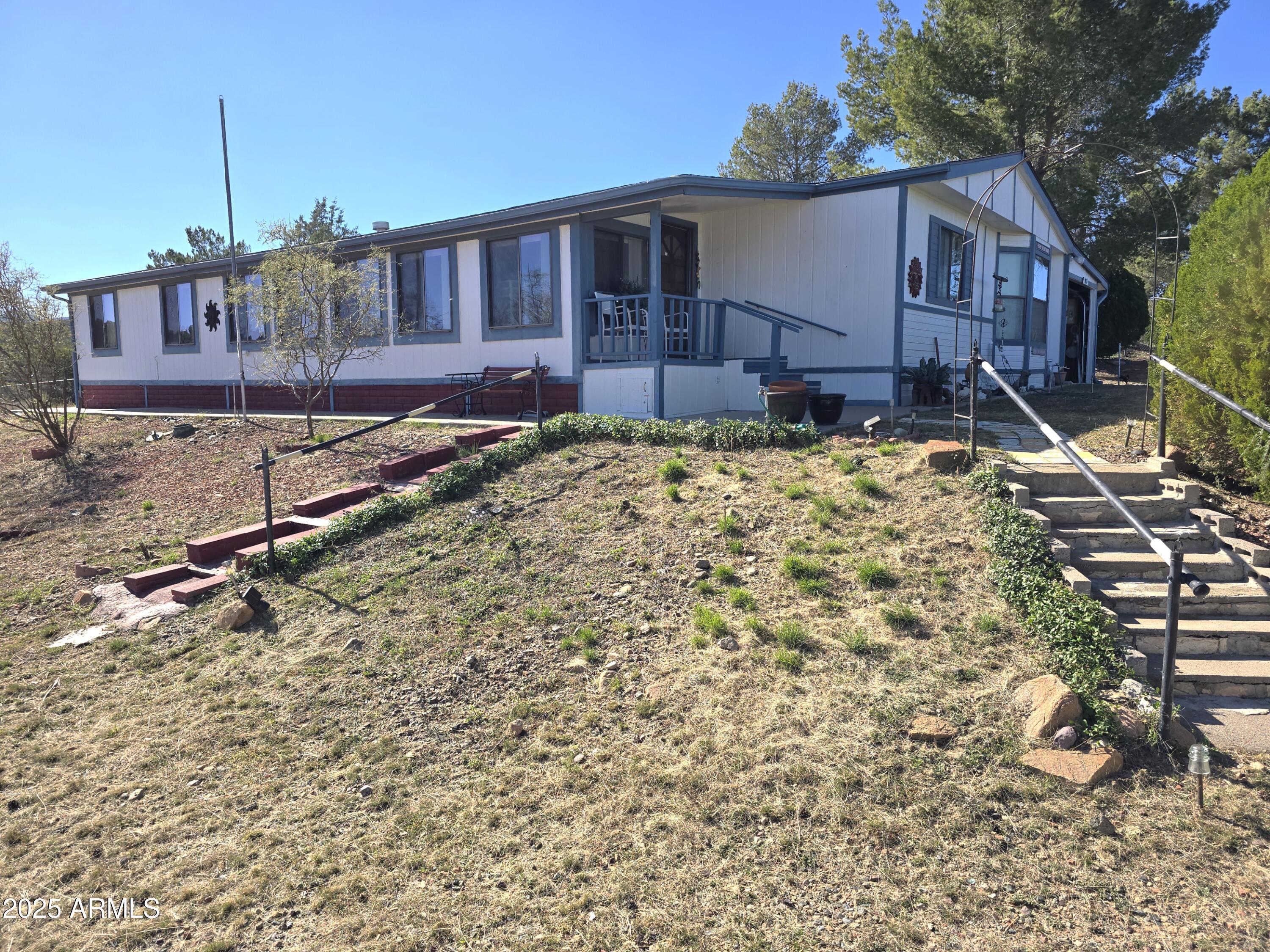 11965 Henderson Road Dewey, AZ 86327 - Photo 2 of 61 a front view of a house with garden