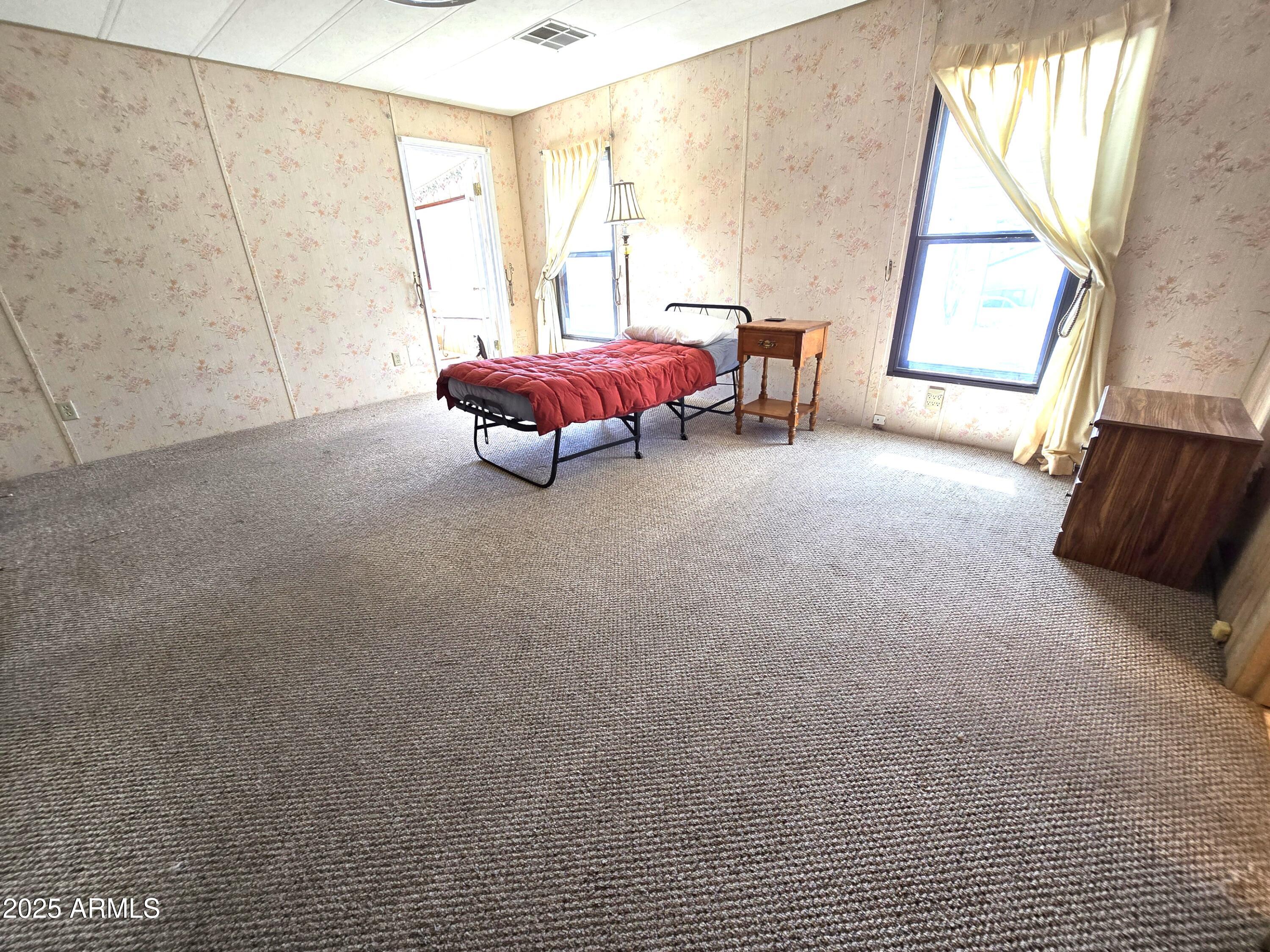 11965 Henderson Road Dewey, AZ 86327 - Photo 25 of 61 a spacious bedroom with a bed and a window