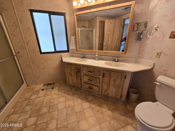 a bedroom with bed and flat screen tv