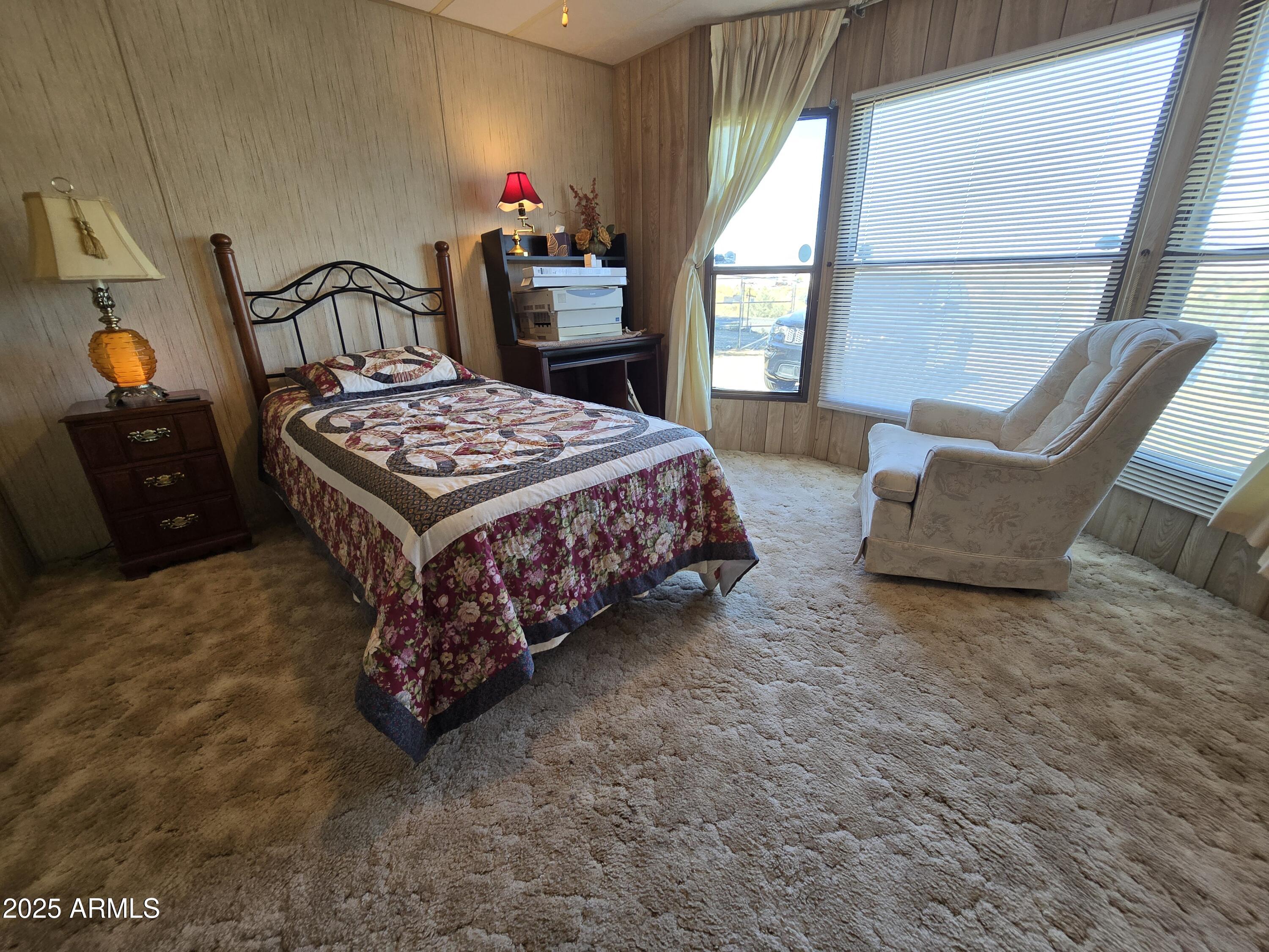 11965 Henderson Road Dewey, AZ 86327 - Photo 30 of 61 a bed sitting in a bedroom next to a window