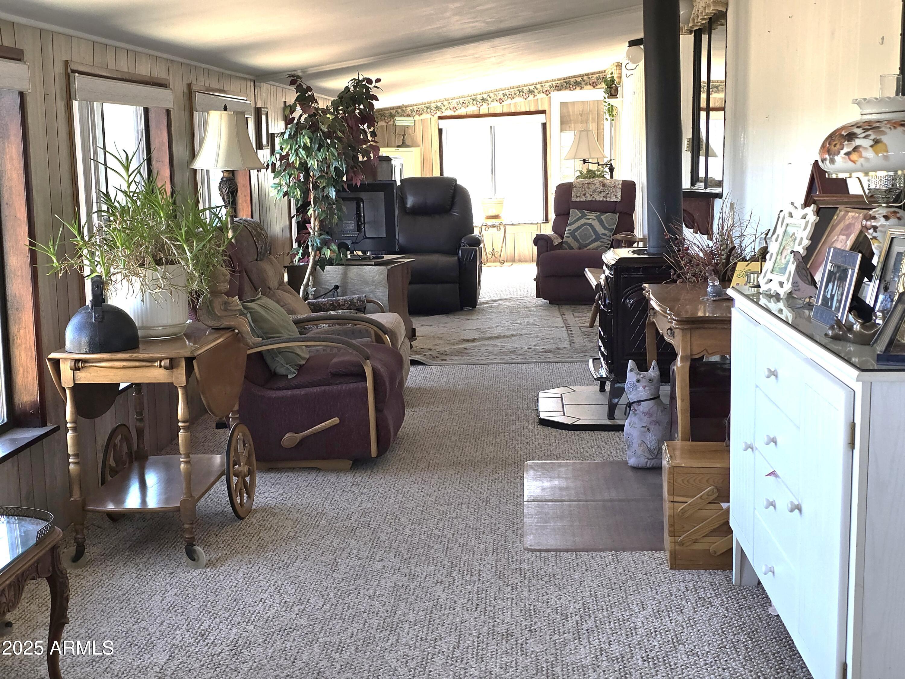 11965 Henderson Road Dewey, AZ 86327 - Photo 38 of 61 a room with lots of white furniture a chandelier and a window
