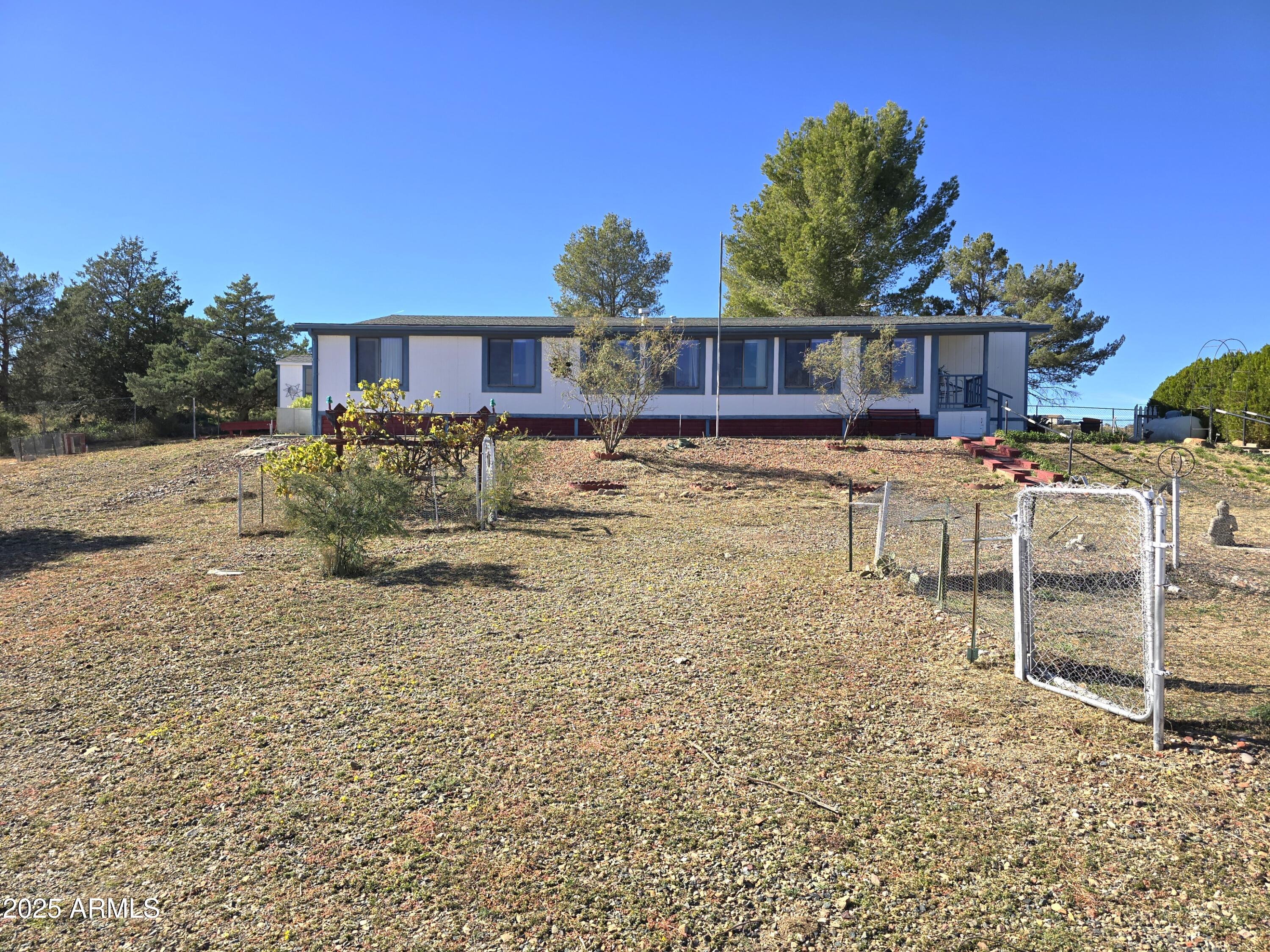 11965 Henderson Road Dewey, AZ 86327 - Photo 8 of 61 a view of a house with a yard