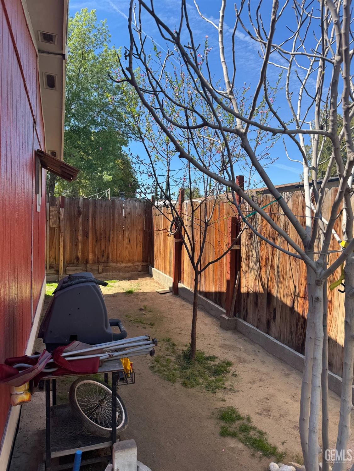 Undisclosed Address Bakersfield, CA 93307 - Photo 14 of 18 a view of a backyard with chairs and a tree