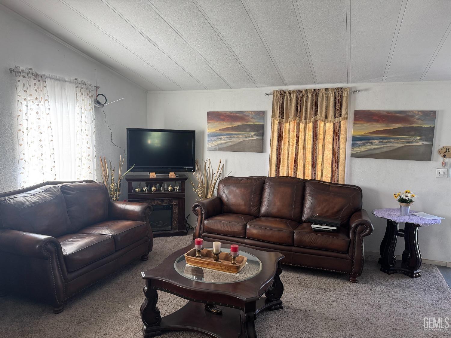 Undisclosed Address Bakersfield, CA 93307 - Photo 6 of 18 a living room with furniture and a flat screen tv
