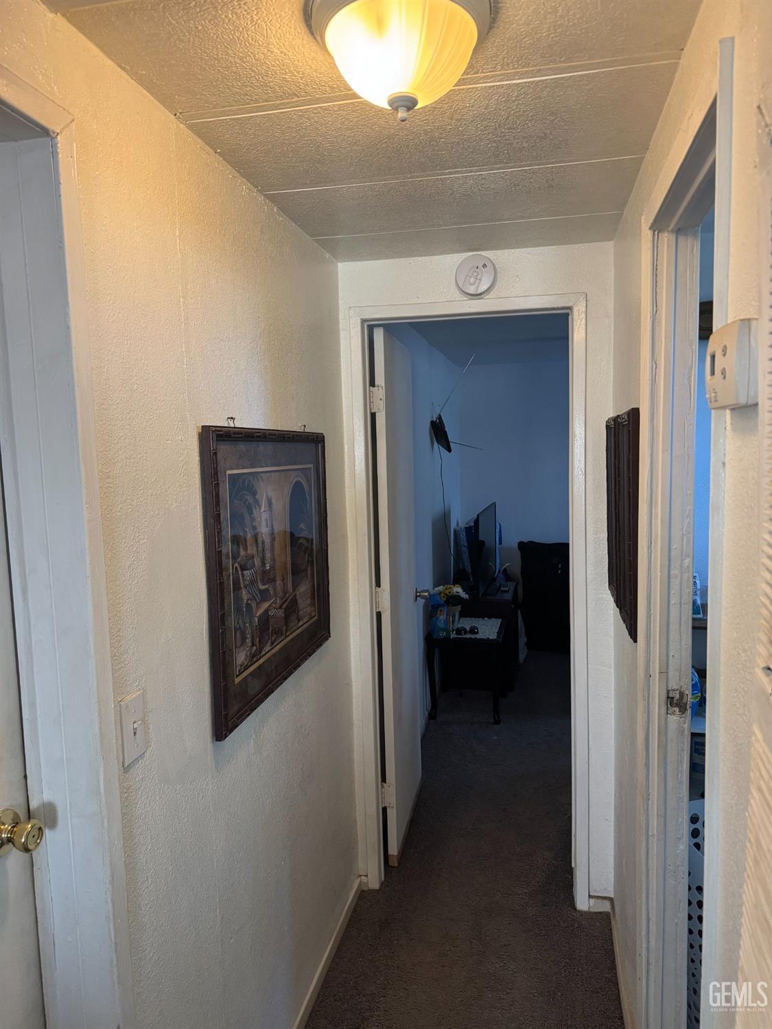 Undisclosed Address Bakersfield, CA 93307 - Photo 8 of 18 a view of a hallway and a livingroom with furniture