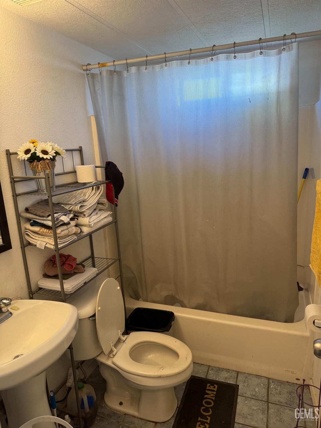 Undisclosed Address Bakersfield, CA 93307 - Photo 9 of 18 a bathroom with a sink toilet and shower