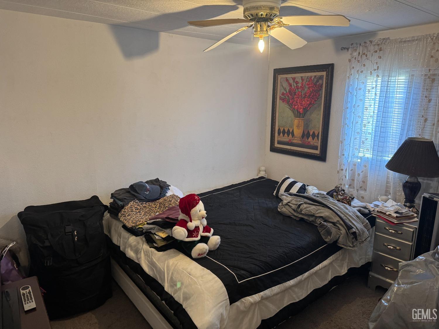 Undisclosed Address Bakersfield, CA 93307 - Photo 10 of 18 a bedroom with a bed and lamp