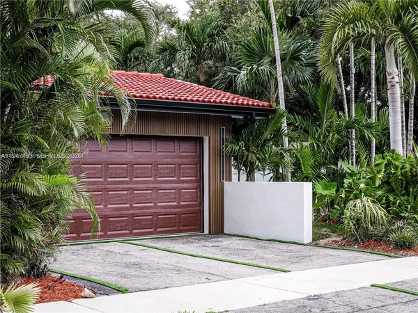 a front view of a house with a garden