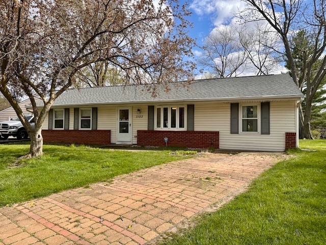3103 Blair Drive Champaign, IL 61821 - Photo 3 of 20 a front view of a house with a garden