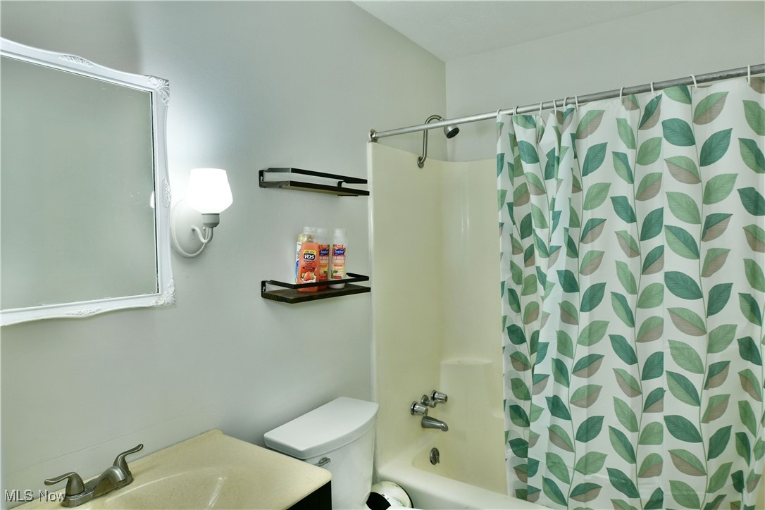 234 Howland Wilson Road Northeast Warren, OH 44484 - Photo 24 of 37 Bathroom with shower / tub combo and vanity