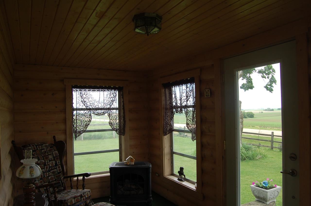 27754 West Elm Road Sterling, IL 61081 - Photo 12 of 19 a living room with hardwood floor and a floor to ceiling window
