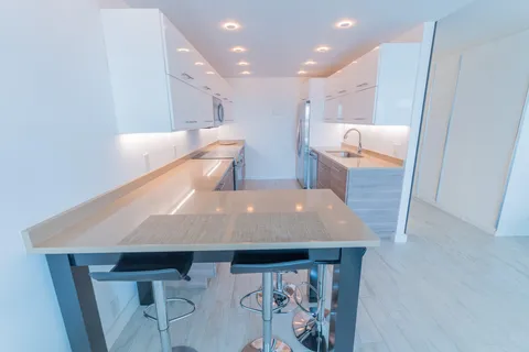 a kitchen with stainless steel appliances a stove a sink and a microwave