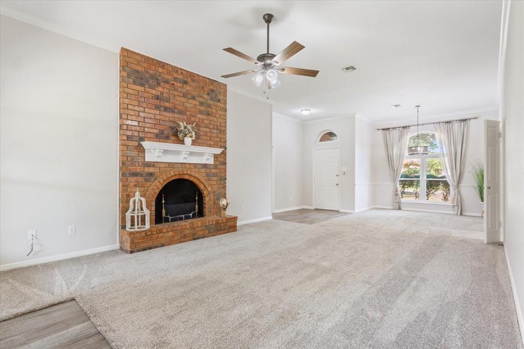 a view of a livingroom with a ceiling fan and fireplace