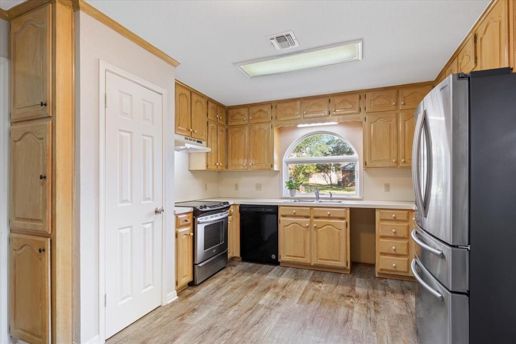327 East Chapman Road Hewitt, TX 76643 - Photo 13 of 30 a kitchen with stainless steel appliances granite countertop a stove a sink and a refrigerator