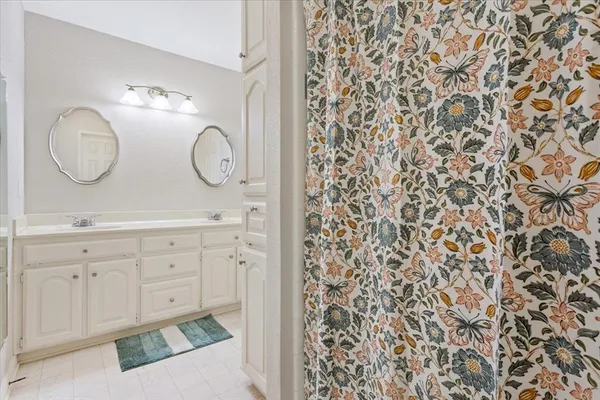 a bathroom with 2 sink and a mirror