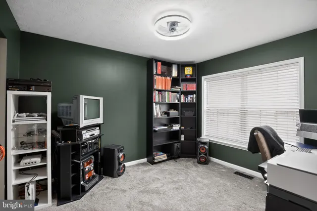 a view of a livingroom with furniture and staircase