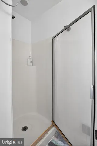 a bathroom with a glass shower door