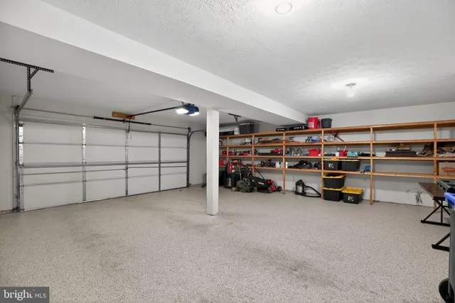 a view of a garage with storage and a white roof