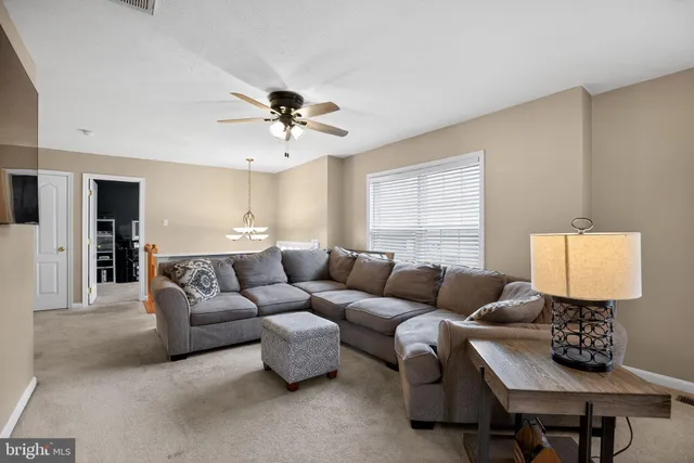 a living room with furniture a lamp and a window