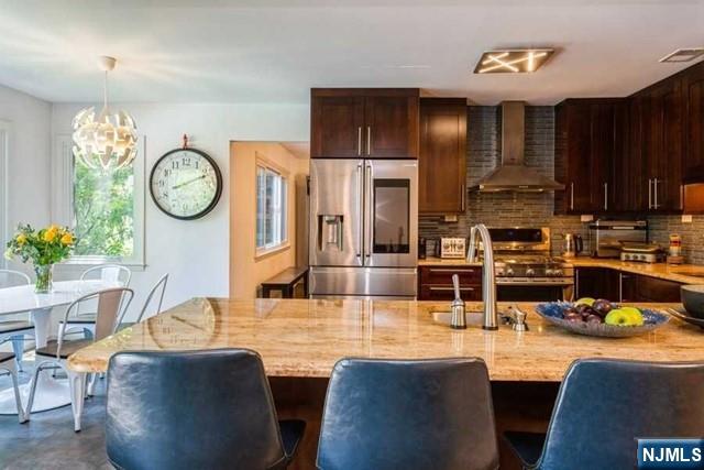 437 Summit Street Englewood Cliffs, NJ 07632 - Photo 11 of 25 a living room with stainless steel appliances granite countertop furniture a fireplace a clock and a window