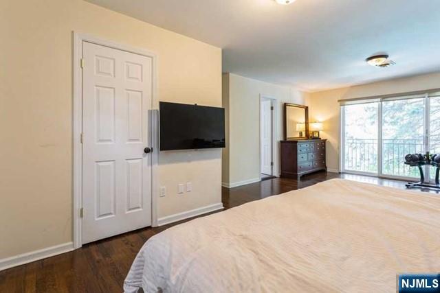 437 Summit Street Englewood Cliffs, NJ 07632 - Photo 20 of 25 a bedroom with a bed and a flat tv screen on wall