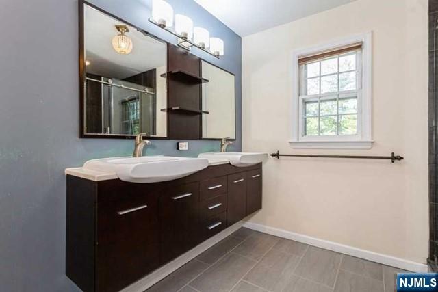 437 Summit Street Englewood Cliffs, NJ 07632 - Photo 21 of 25 a bathroom with a sink vanity and mirror