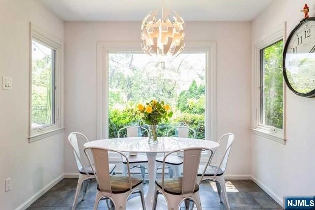 437 Summit Street Englewood Cliffs, NJ 07632 - Photo 9 of 25 a view of a dining room with furniture a potted plant and wooden floor