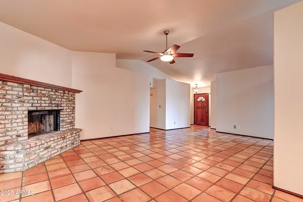 a view of an empty room with a fireplace