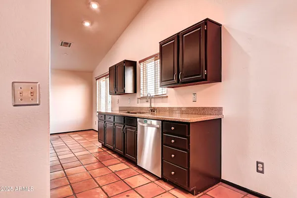 a kitchen with stainless steel appliances granite countertop a stove and a microwave oven on the granite countertops