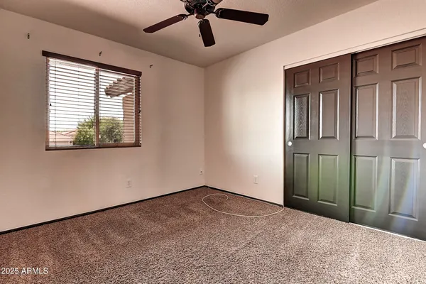 a view of a livingroom with a ceiling fan and window