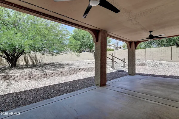a front view of a house with a tree