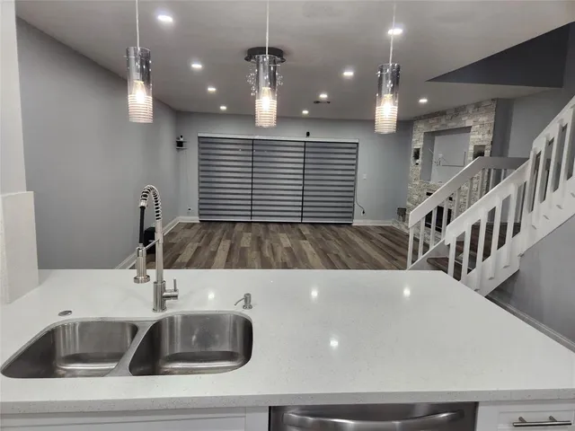 a kitchen with kitchen island a sink stainless steel appliances and cabinets