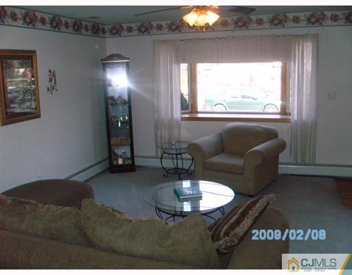 24 Stony Road Edison, NJ 08817 - Photo 4 of 7 a living room with furniture and a chandelier